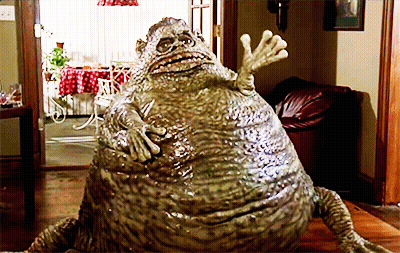 Frog Statue Sitting On Wooden Floor GIF