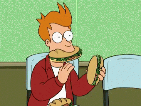 Fry From Futurama Is Eating A Sandwich While Sitting In A Chair . GIF
