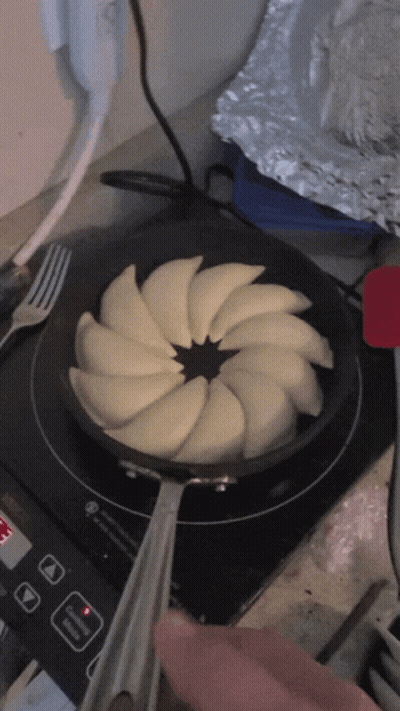 Frying Pan With Sliced Apples On Stove GIF