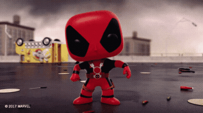 Funko Pop Deadpool In Front Of Yellow Truck GIF