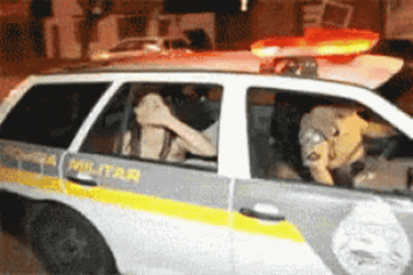 Funny Girl Riding Police Car Waving Goodbye Kiss GIF