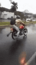 Funny Rain Man Doing Motorbike Tricks GIF