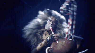 Furry Man Playing Flute In Dark Room GIF