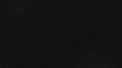 Gal Surrounded By Smoke In Dark Room GIF