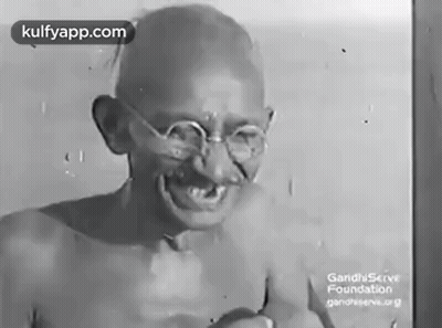 Gandhi Smiling In Black And White With Glasses GIF