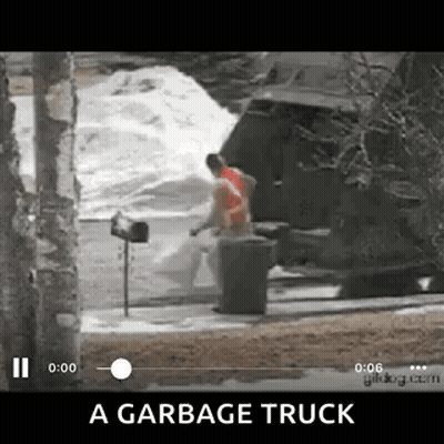 Garbage Truck Driving Down Street Next To Mailbox And Trash Can GIF