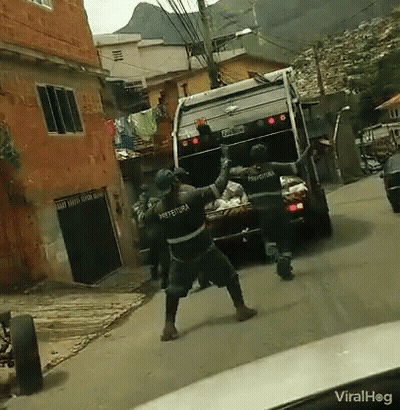 Garbage Truck With Prefeitura On Back Driving Down Street GIF