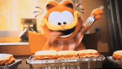 Garfield Is Holding A Fork And Eating A Tray Of Food . GIF