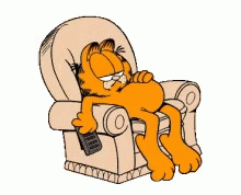 Garfield Is Laying In A Chair With A Remote In His Hand GIF