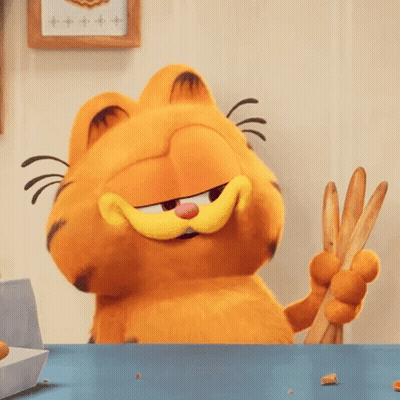 Garfield The Cat Is Sitting At A Table Holding A Pair Of Tongs . GIF