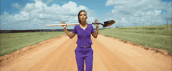 Gaunt Lady Singing While Holding Shovel GIF