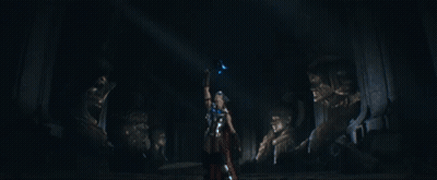 Giant Robot Standing In Front Of City With Sun Shining Through Clouds GIF