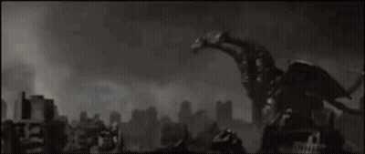 Giant Robot Standing In Front Of City With Sun Shining Through Clouds GIF