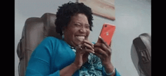 Giggling Woman At Phone GIF