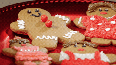 Gingerbread Cookies On A Red Plate With One That Says ' I 'M A Gingerbread Man ' On It GIF
