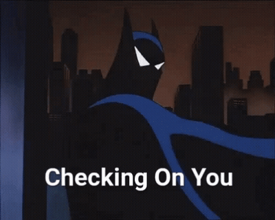 Giraffe Laying In Front Of Building GIF