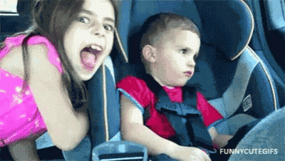 Girl And Boy Sitting In Car Seat GIF