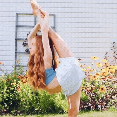 Girl Doing Split In Front Of Flowers GIF