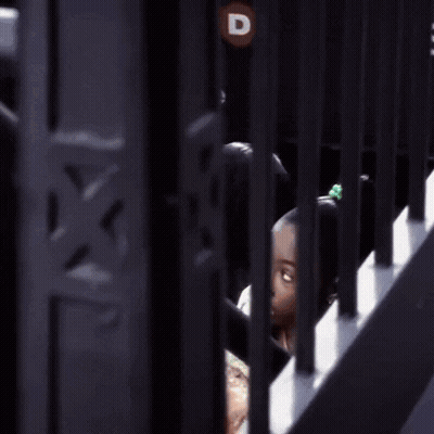 Girl Eating Pizza Behind Bars GIF