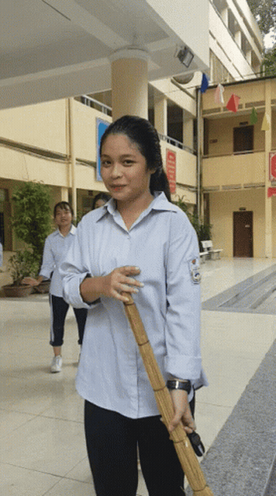 Girl Holding Broom With A Sign GIF