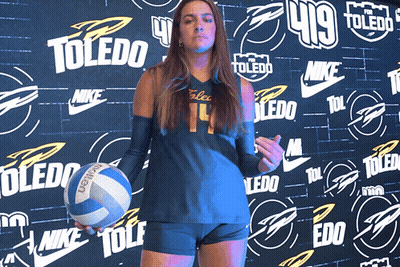 Girl Holding Volleyball In Front Of Toledo Wall GIF