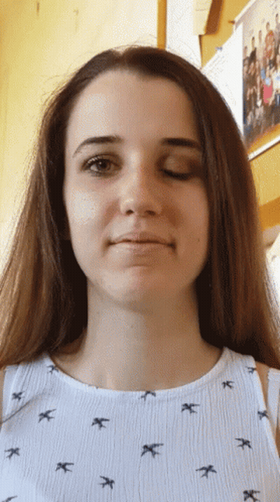 Girl In Bird Shirt Looking At Camera GIF