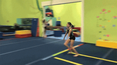 Girl In Black Leotard Jumping On Trampoline GIF