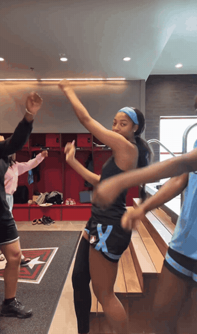 Girl In Black Tank Top And Blue Shorts Dancing In Locker Room GIF
