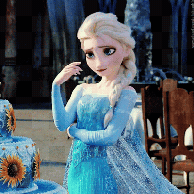 Girl In Blue Dress In Front Of Blue Cake With Sunflowers GIF