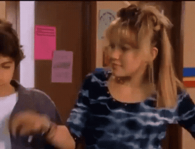 Girl In Blue Dress Next To Boy In Hallway GIF