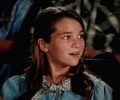 Girl In Blue Dress With Floral Collar GIF