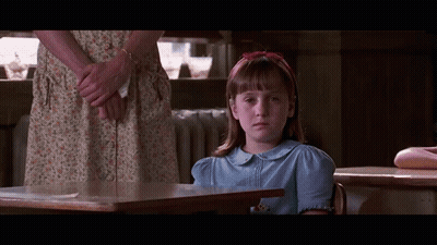 Girl In Blue Shirt At Desk GIF
