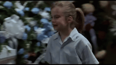 Girl In Blue Shirt With Christmas Tree GIF
