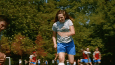 Girl In Blue Shorts Jumping While Playing Soccer GIF