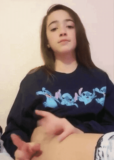 Girl In Blue Stitch Sweatshirt Touching Belly GIF