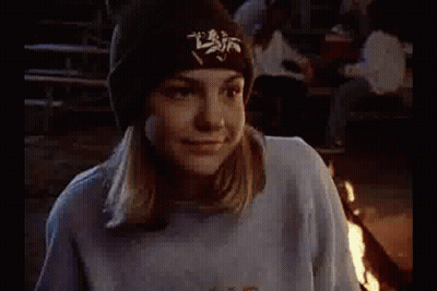 Girl In Blue Sweatshirt And Black Hat Sitting Next To Man GIF
