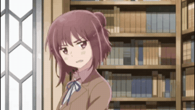 Girl In Brown Suit In Front Of Bookcase GIF