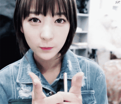 Girl In Denim Jacket Holding Lollipop GIF