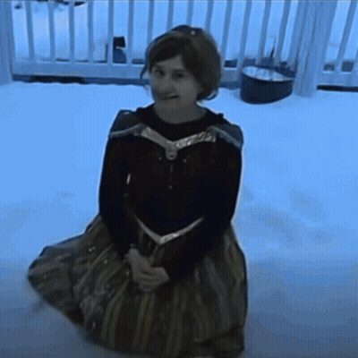 Girl In Frozen Costume Kneeling In Snow GIF