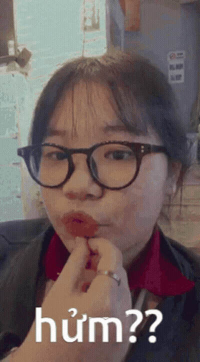 Girl In Glasses And Red Shirt Making Funny Face GIF