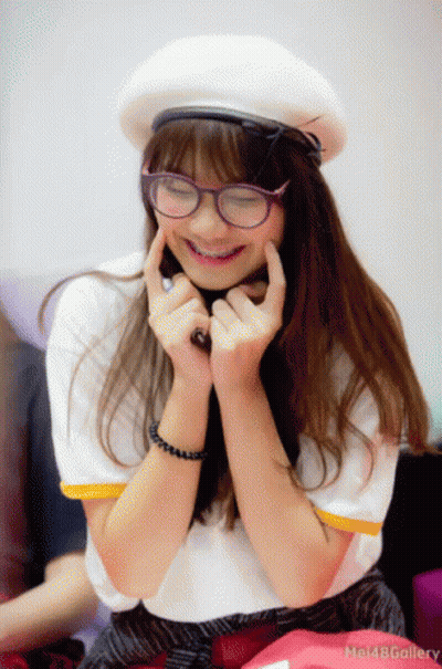 Girl In Glasses And White Hat Smiling Hands On Chin GIF