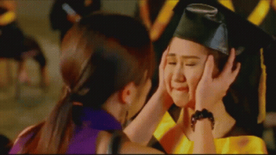 Girl In Graduation Cap And Gown Being Comforted GIF