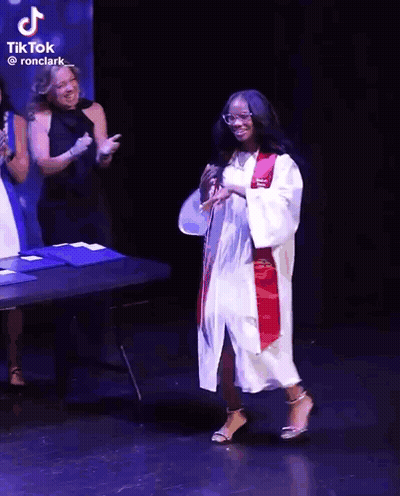 Girl In Graduation Cap And Gown Dancing GIF