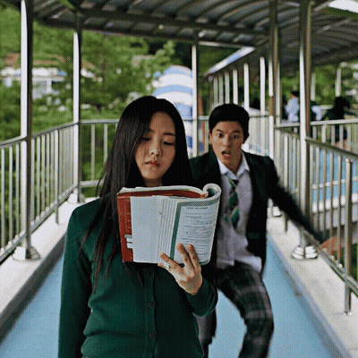 Girl In Green Cardigan Holding Book Saying Physics GIF