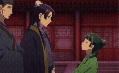 Girl In Green Dress Talking To Man In Black Robe GIF