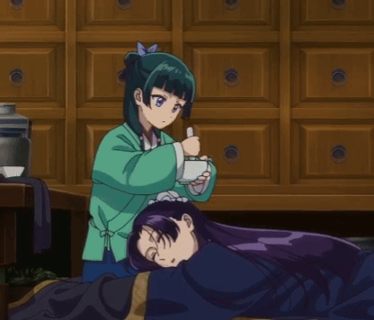 Girl In Green Jacket Holding Cup Another Girl Lays On Floor GIF