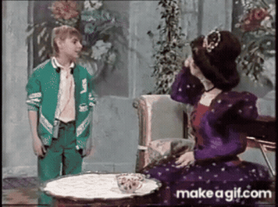 Girl In Green Jacket Next To Woman In Purple Dress GIF