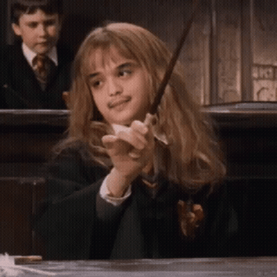 Girl In Harry Potter Costume Holding Wand GIF