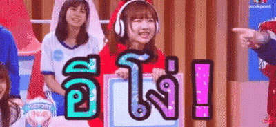 Girl In Headphones And Santa Hat Holding Victory Sign GIF