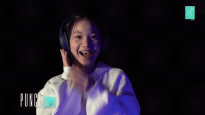 Girl In Headphones And White Hoodie Saying Punch Board GIF